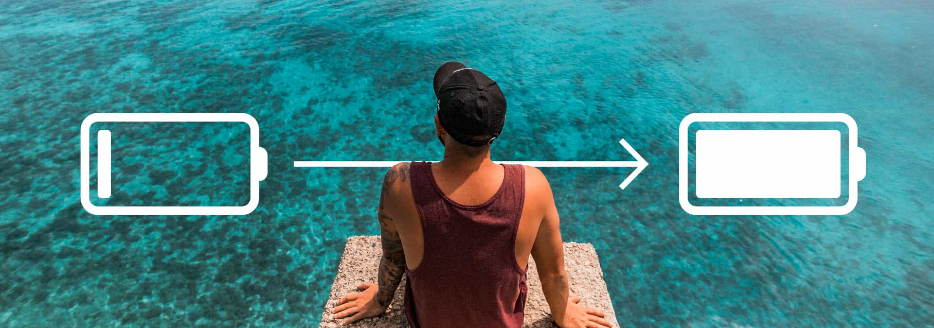 A man sitting by clear-blue water with a graphic of an empty battery on his left and a full battery on his right.