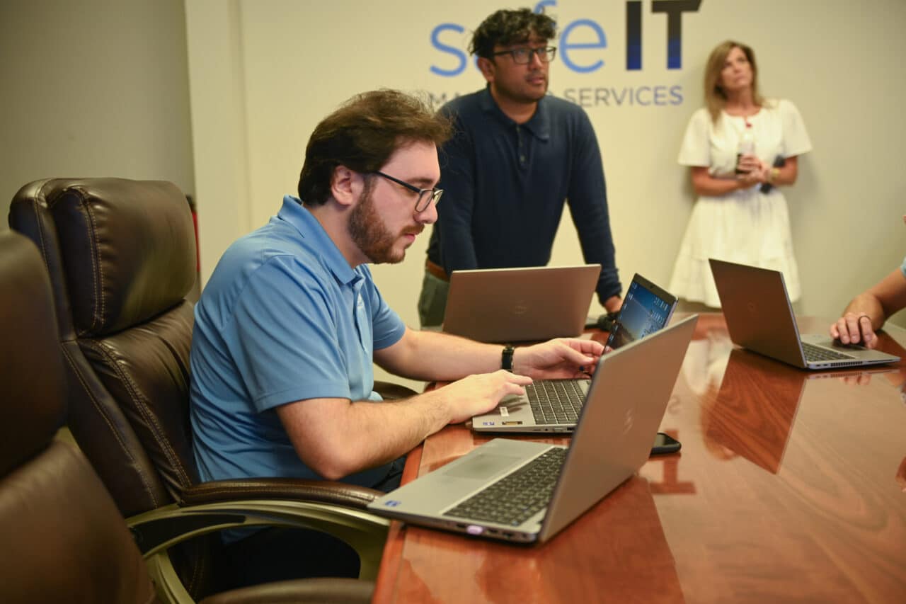 Technician typing on a computer.